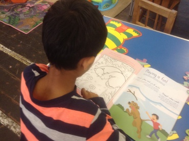 Lad using PETA colouring book