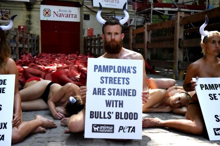 Pamplona holding a sign