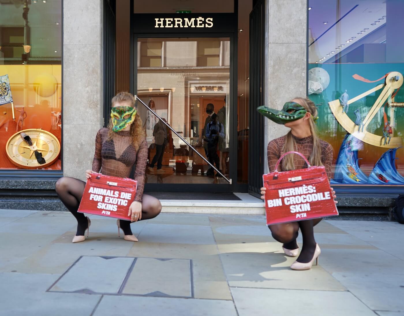 London, UK. 28th May 2022. Animal rights activists gathered outside the  Hermes store in Bond Street in protest against the use of crocodile and  other animal skins in the fashion brand's products.