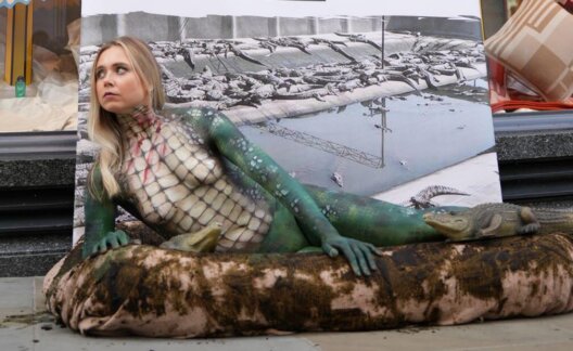An activist dressed as a crocodile outside Hermes in London
