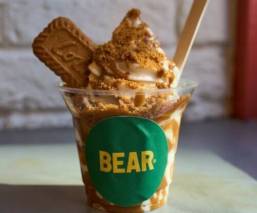 A vegan sundae from Bear featuring crumbled Biscoff and a whole Biscoff biscuit - with a green label reading "Bear" on the carton