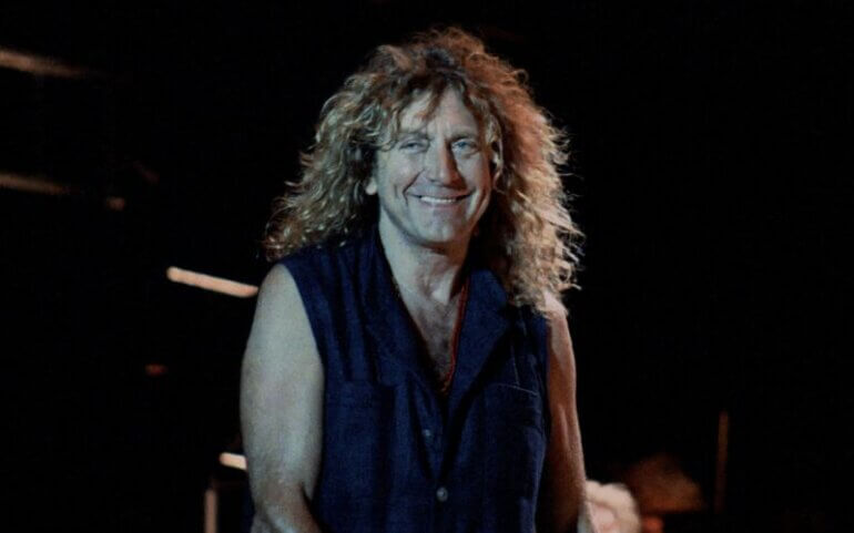 Led Zeppelin frontman Robert Plant in front of a black background