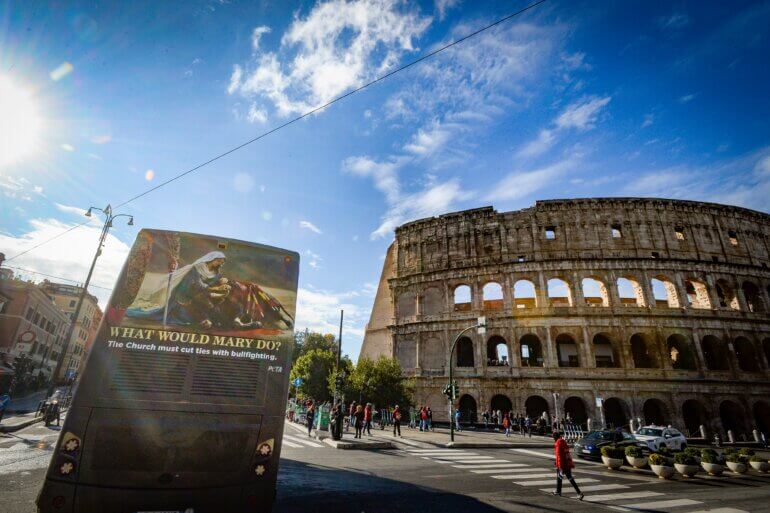 A bus advert urging the Catholic Church to cut ties with bullfighting next to the Colosseum