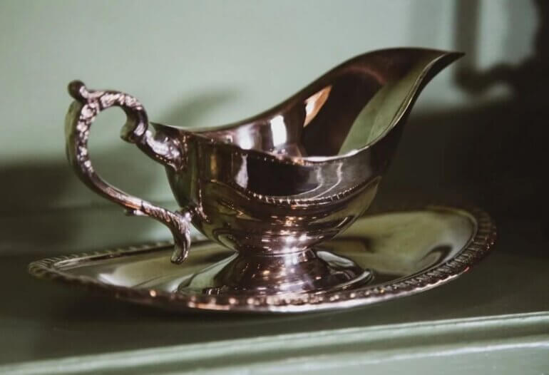 A gravy boat containing red wine gravy