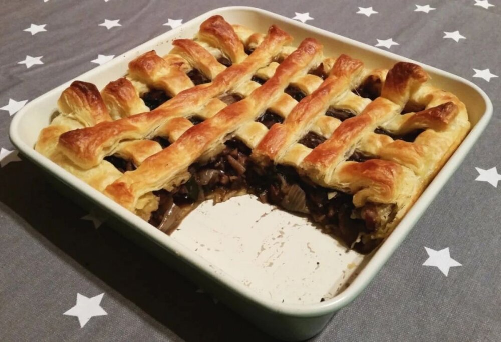 A chestnut and mushroom pie served in a white dish