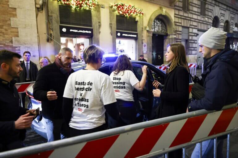 Two PETA supporters being arrested while protesting against the Catholic Church