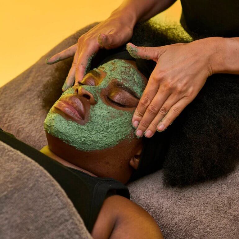 A woman receiving a head massage at a spa