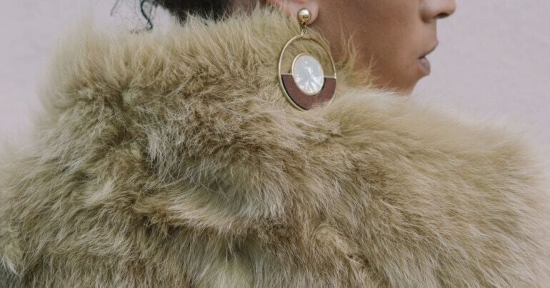 A woman wearing a faux fur coat