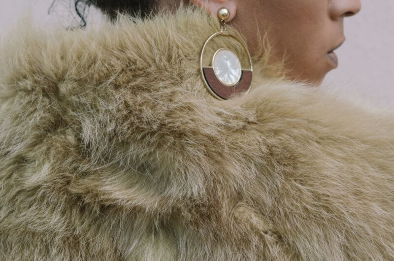 A woman wearing a faux fur coat