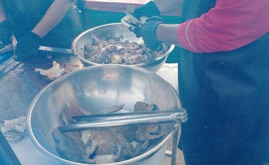 A worker cutting up frogs at a frogs legs market in Thailand