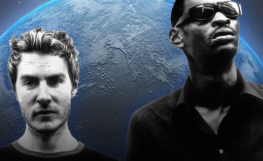 Two members of Massive Attack in front of a background depicting the world