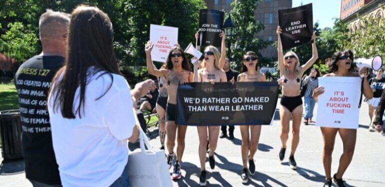 PETA activists hold up a sign saying "I
