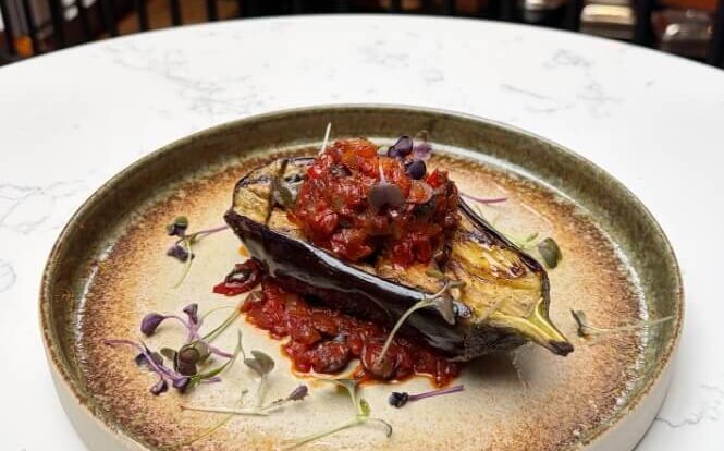 An Aubergine Provençal with grilled aubergine, tomato and vegetable ratatouille - a vegan dish from Mercure Hotel