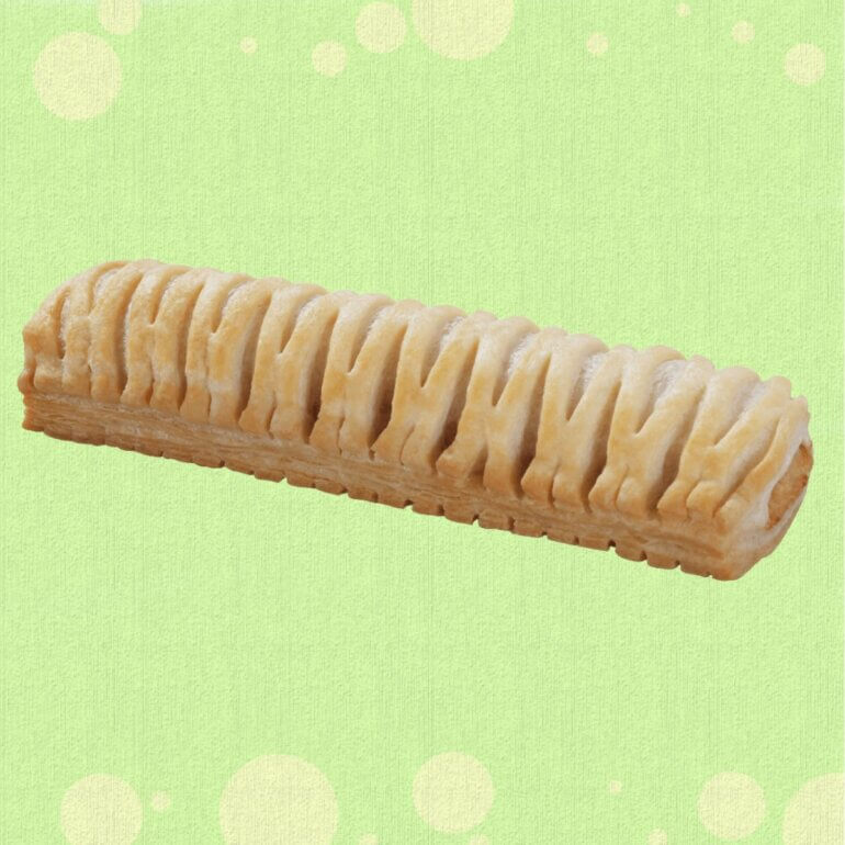 A Greggs vegan sausage roll in front of a green background