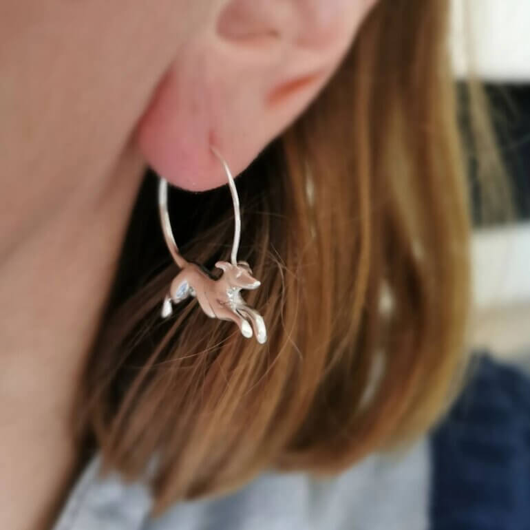 A woman wearing a greyhound earring