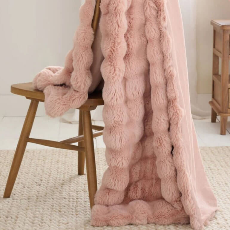 A pink blanket on a chair