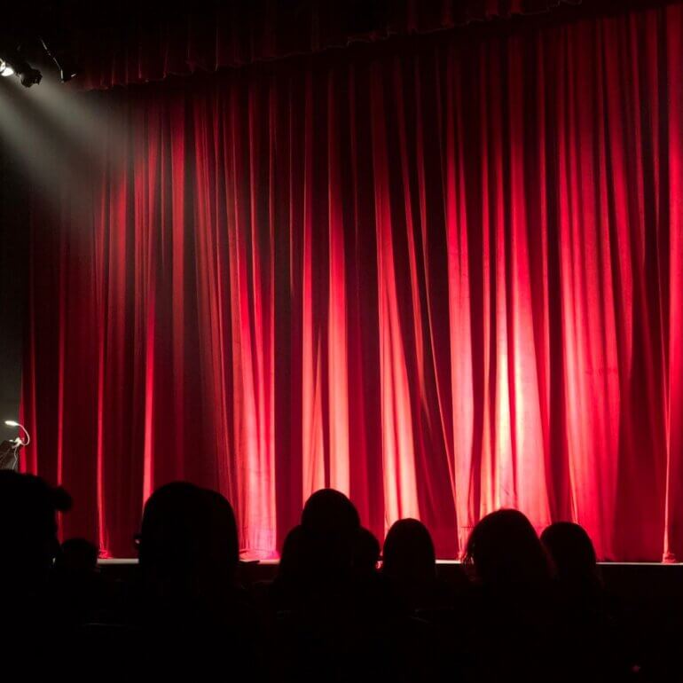 People watching a play at the theatre