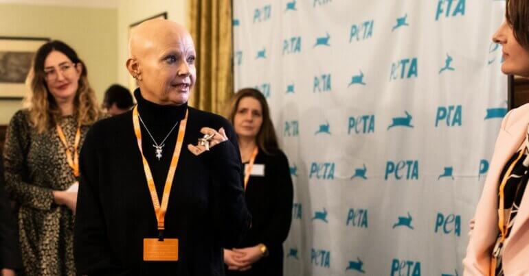 TV personality and animal advocate Gail Porter standing in front of a PETA background