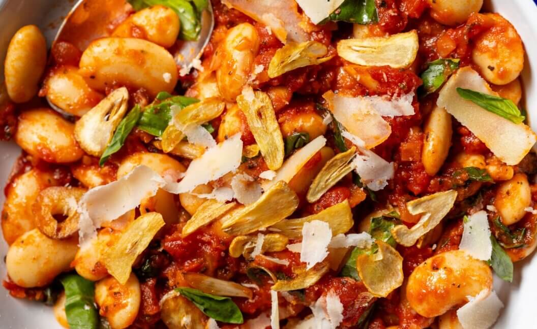 A close-up of a bowl of butter bean arrabbiata