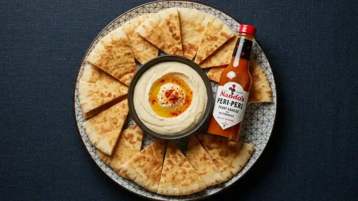 A plate of Nando's pitta and houmous with PERi-PERi drizzle