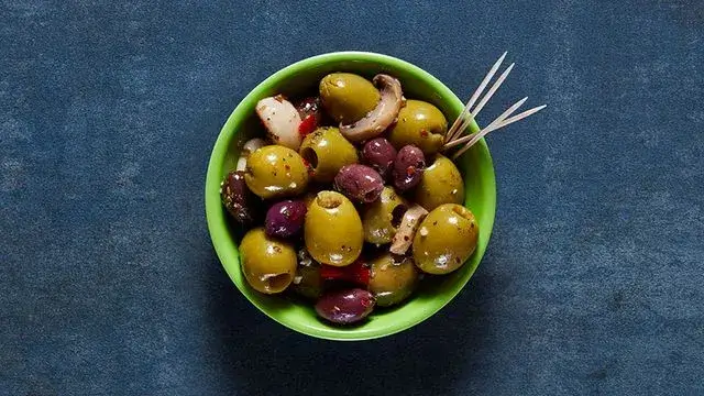 A bowl of Nando's spicy olives from the plant-based menu
