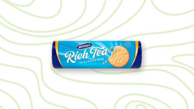 A packet of Rich Tea biscuits in front of a green pattern background