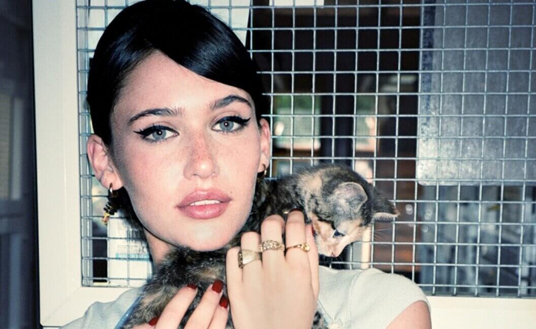 Sienna Spiro holding a rescued cat in an animal shelter